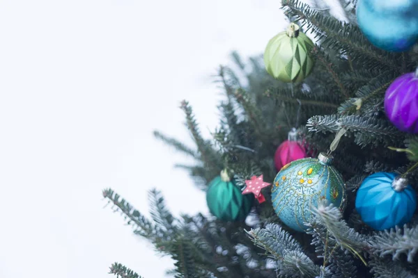 A decorated Christmas tree outside with blue and purple shiny balls — Stock Photo, Image