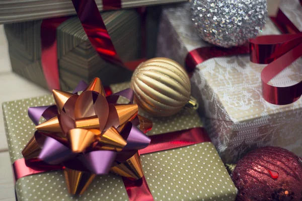 A gift box in a close up with other gift boxes and ornaments — Stock Photo, Image