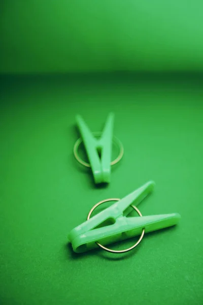 Green plastic clothes pegs