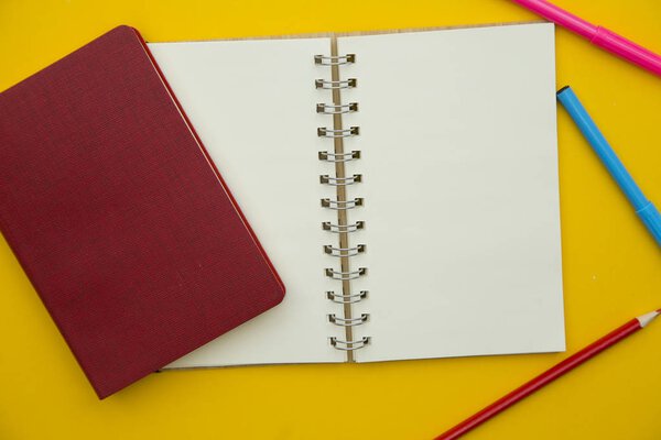 two notebooks on a yellow background