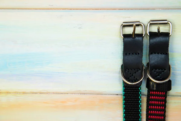 Dog collars on wooden background