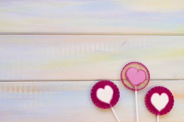 St. Valentines wooden background with lolipops — Stock Photo, Image