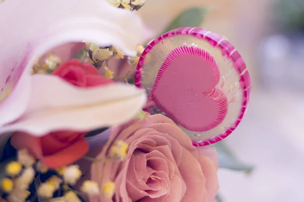 Una cesta de flores y caramelos lolipop — Foto de Stock