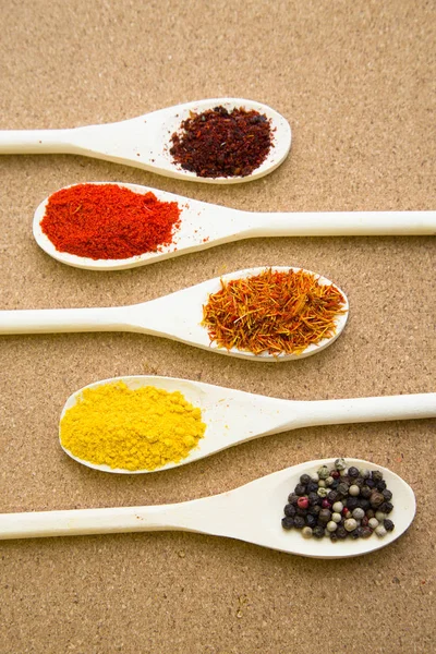 Set of spices and herbs on a corkwood — Stock Photo, Image