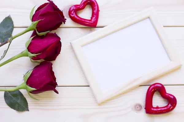 Red roses and photo frame