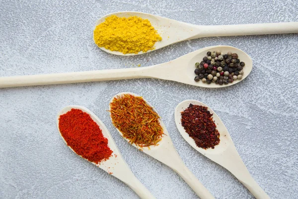 Set of spices and herbs on light stone background — Stock Photo, Image