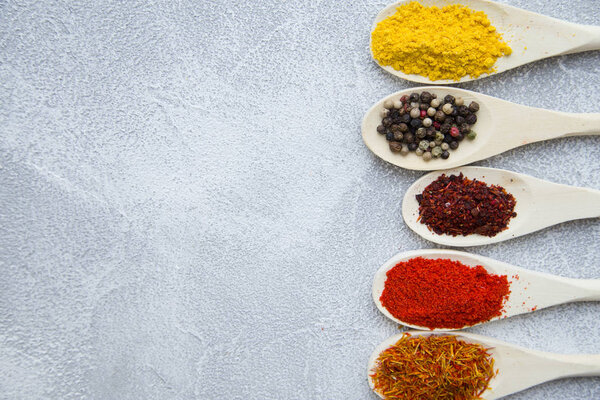 Set of spices and herbs on light stone background