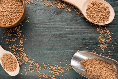 Tahta kaşık ve buğday ile kase. Arka plan