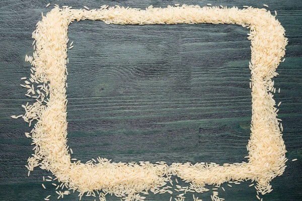 Bir çerçeve bir ahşap koyu yeşil masada beyaz pirinç. Arka plan