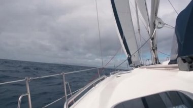 Önden Görünüm dalgalar fırtına sırasında sallanan beyaz yelkenli gemide. Fırtınalı denizde gidiş yat okyanus. Yan görünüm