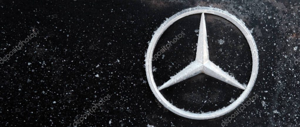Kazakhstan, Kostanay, 2019-01-19. Mercedes iconic logotype covered with snow flakes. Winter. Close-up. The trunk of a black car. Copy space. Mercedes-Benz is automobile manufacturer and division of German company Daimler AG.