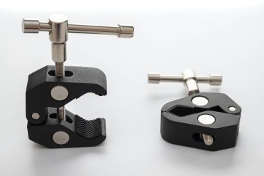 DSR ya da aynasız kamera için iki şarjör. Fotoğraf aksesuarları. İkisi de 14 ve 38 inçlik vidalar. Sihirli Sürtünme Kolu Küçük Süper Kıskaç Yengeç Pensesi. Beyaz arkaplan ve doku. İzole değil.