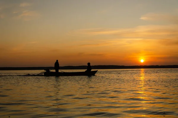 The fishermen and boat silhouette