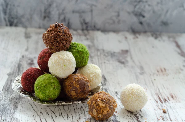 Sweet chocolate truffles on the white background