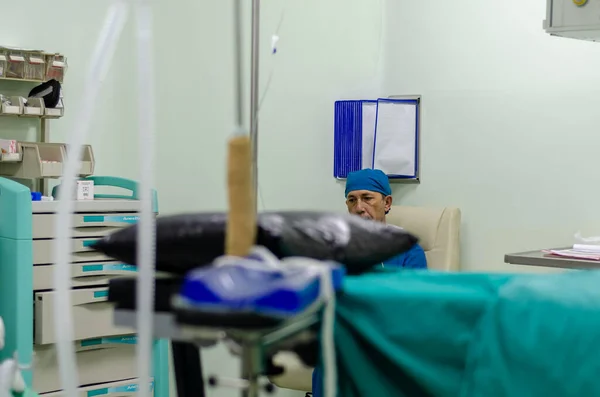 Male surgical doctor is sitting in the operating room