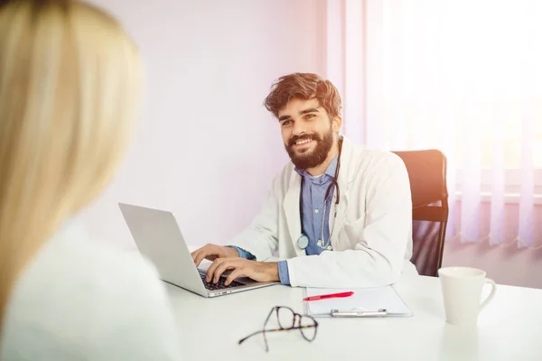 Smiling doctor giving good news. Doctor reviewing good test results to a patient.