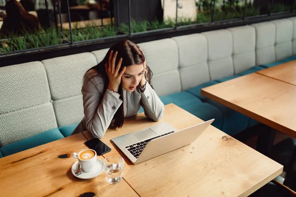 Woman Holding Head While Sitting Front Laptop Computer — Stock Photo, Image