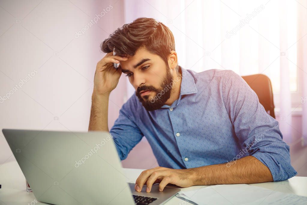 Concerned businesswoman using laptop computer.