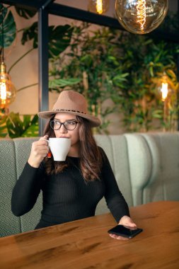 Genç kadın şehir kafede kahve içme.