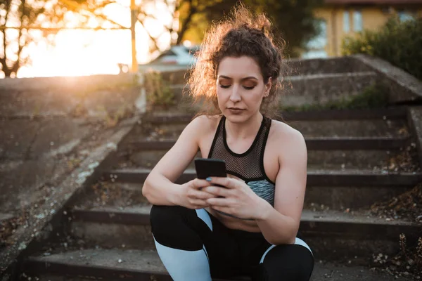 Young Woman Sportswear Using Mobile Phone While Sitting Stairs Outdoors — Stock Photo, Image