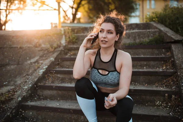 Young Fit Sportswoman Sitting Stairs Having Phone Call — Stock Photo, Image