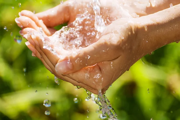 Woman washing hand outdoors. Hands with water splash, selective focus — Stock Photo, Image