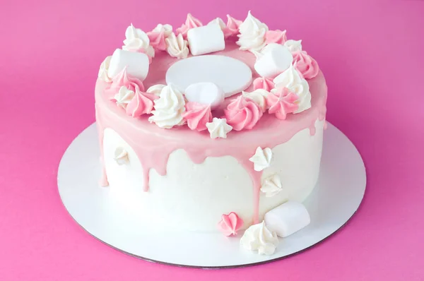 Birthday pink cake for girl, decorated with marshmallow, meringue cookies on a pink background. Cutout. Picture for a menu or a confectionery catalog.