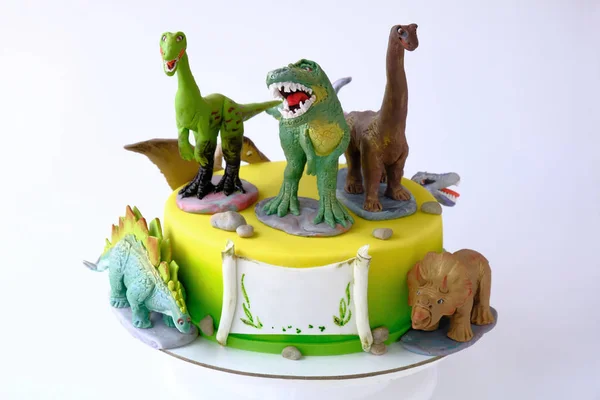 Art cake with different dinosaurs. Gift for the boy. Picture for a menu or a confectionery catalog.