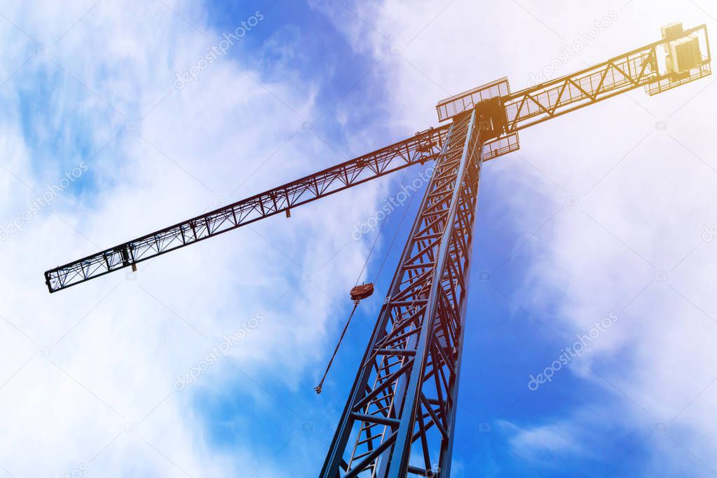 Crane jenny on construction process, blue sky clouds background