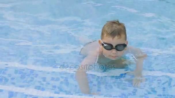 Niño en gafas para nadar en la piscina — Vídeo de stock