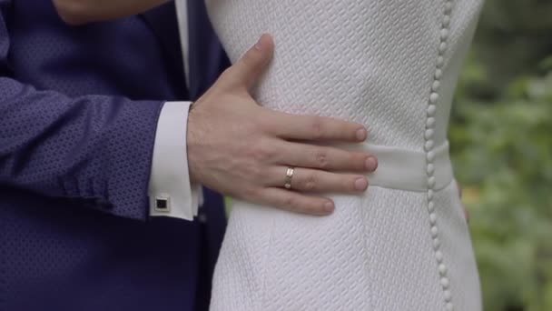 Bridegroom embraces the bride with one hand — Stock Video