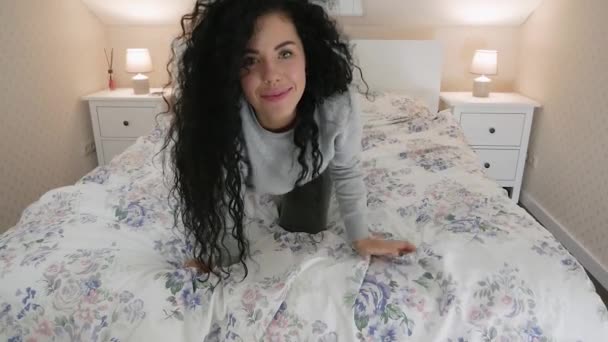 Cute Woman looking at slow motion on her bed in bedroom — Stock Video