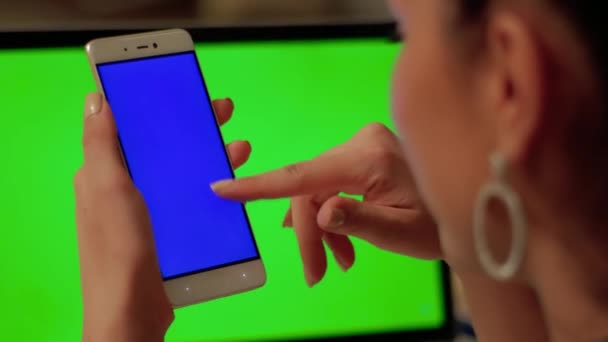 Girl touches phone with blue screen — Stock Video