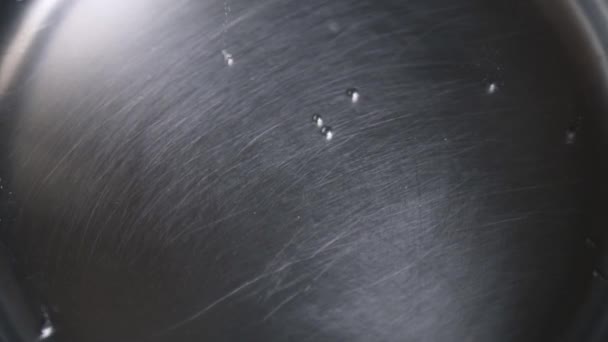 Water boils in a metal pan, little bubbles — Stock Video