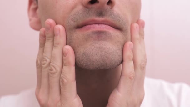 Um homem cuida da pele do rosto depois de fazer a barba — Vídeo de Stock