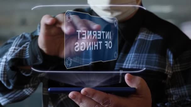 Old man shows hologram with text Internet of things — Stock Video