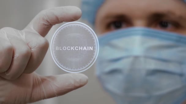 Doctor looks at hologram with Blockchain — Stock Video