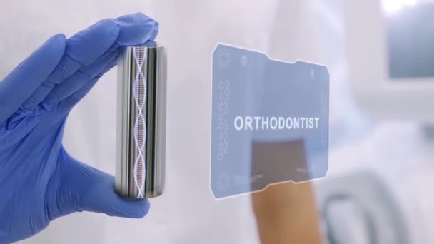 Hand in glove with hologram Orthodontist — Stock Video