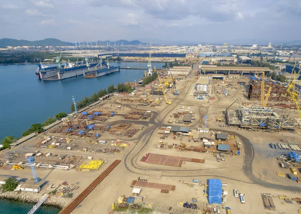 aerial view heavy machinery in shipyard by the sea.