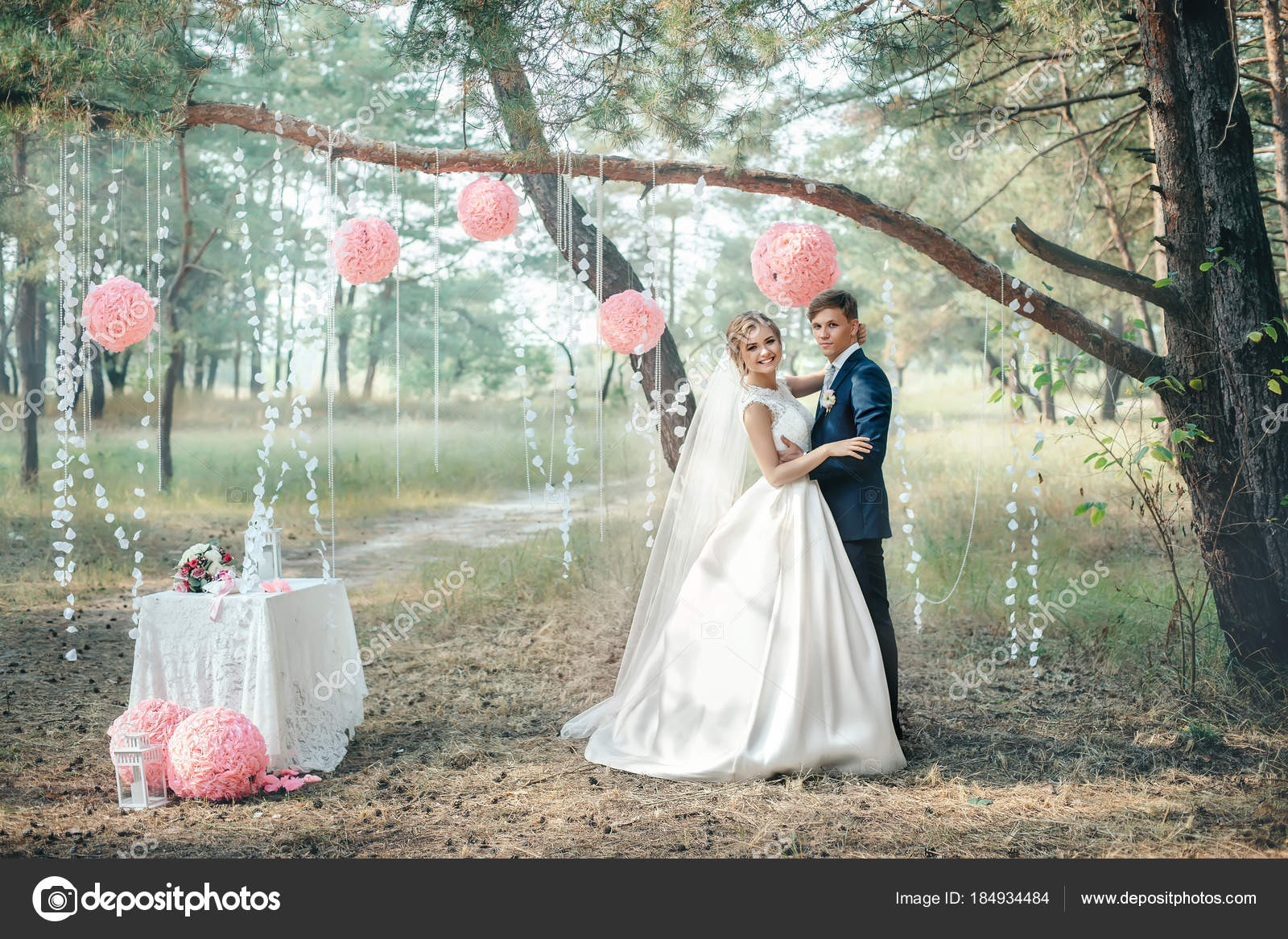 The bride and groom in wedding dresses on natural background. Wedding day.  Newlyweds are walking through the forest. Stock Photo by ©shulgenko007  184934484
