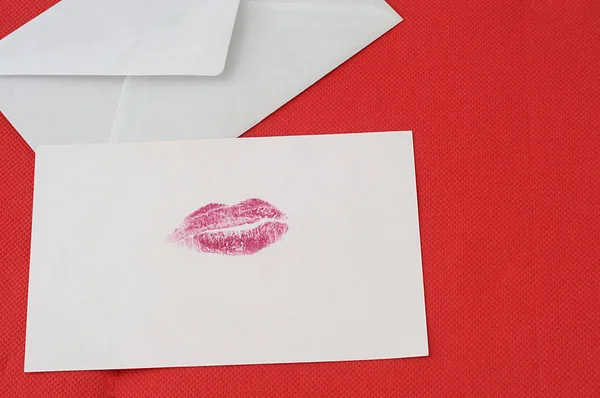 Red love background, letter with a red kiss