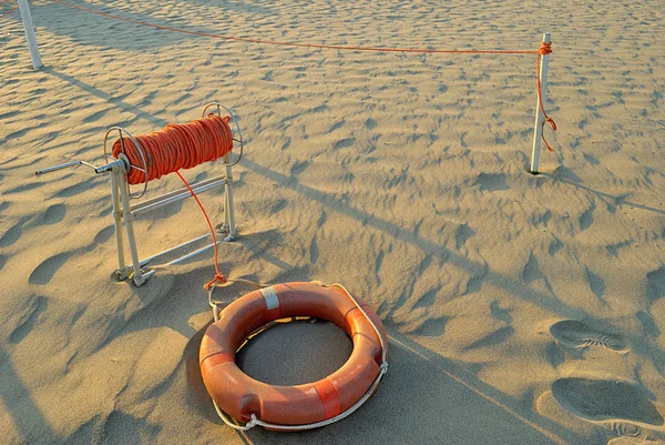 Summer sea, orange lifebuoy on the beach with a lot of orange  r — Stock Photo, Image