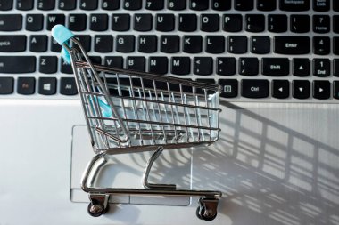 İnternetten alışveriş yapmak - alışveriş arabası ya da dizüstü bilgisayarda tramvay. İnternet 'te alışveriş hizmeti.