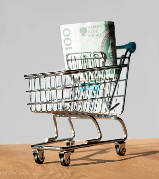 Shopping cart filled with polish zloty - banknotes - currency, money in shopping cart — Stock Photo, Image