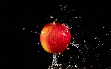 red apple with splashing water drops