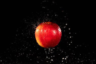 red apple with splashing water drops