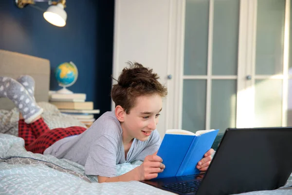 Young caucasian boy studying at home with online courses during the coronavirus quarantine. Distance education concept