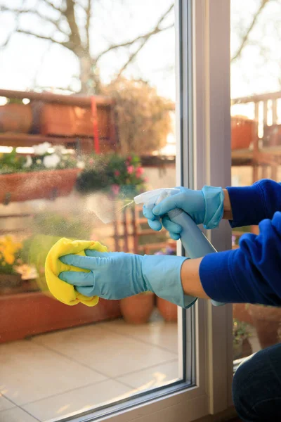 housekeeping: cleaning the windows, Window cleaner using a squeegee, sponge and soap suds to wash a window