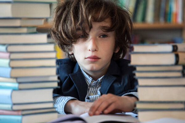 Learning at home, online learning, self quarantine concept. Children doing homework with books, textbooks and with computer online