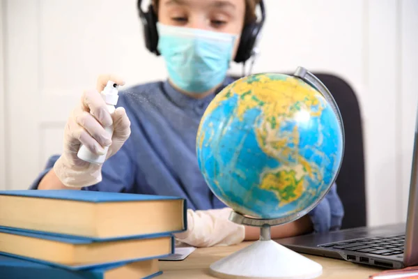 Distance learning online education. A schoolboy boy studies at home and does school homework. A home distance learning , Coronavirus pandemic in the world. Closing schools